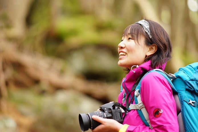 カメラを構える女性登山者