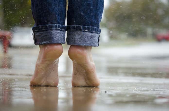 雨の中裸足で立っている人