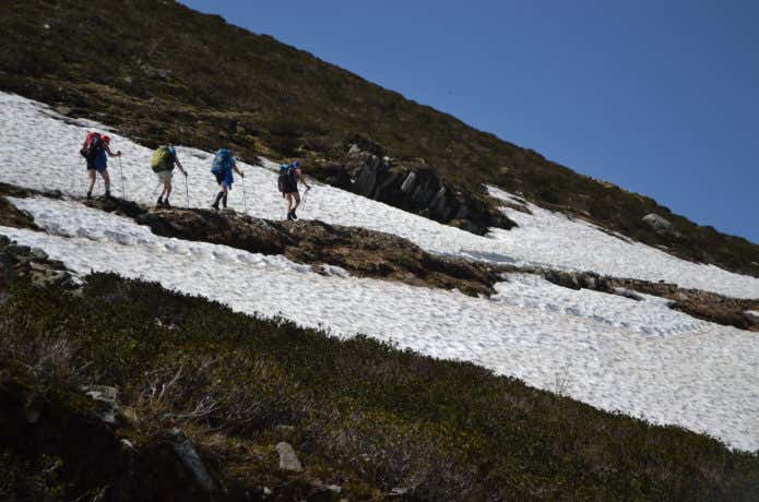 残雪期にグループで登山をする人