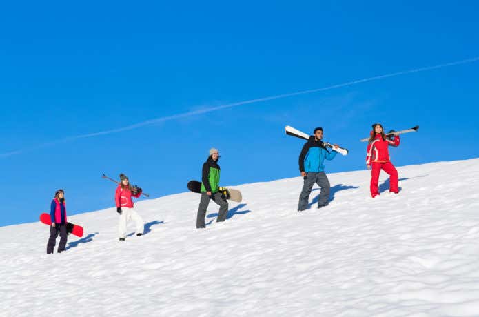 スノーボードとスキーをしている人々