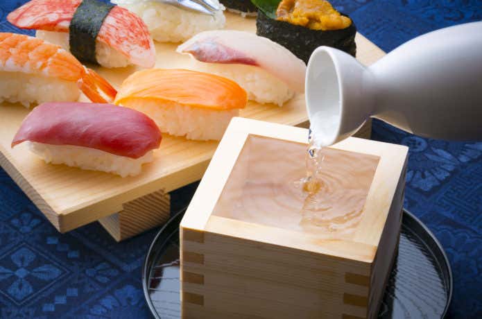 寿司と日本酒を注ぐ様子