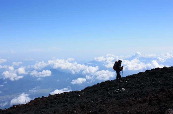 晴れている富士山に登る人