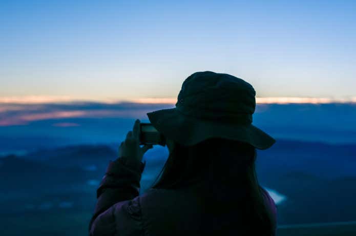 カメラで夜景を撮影する女性
