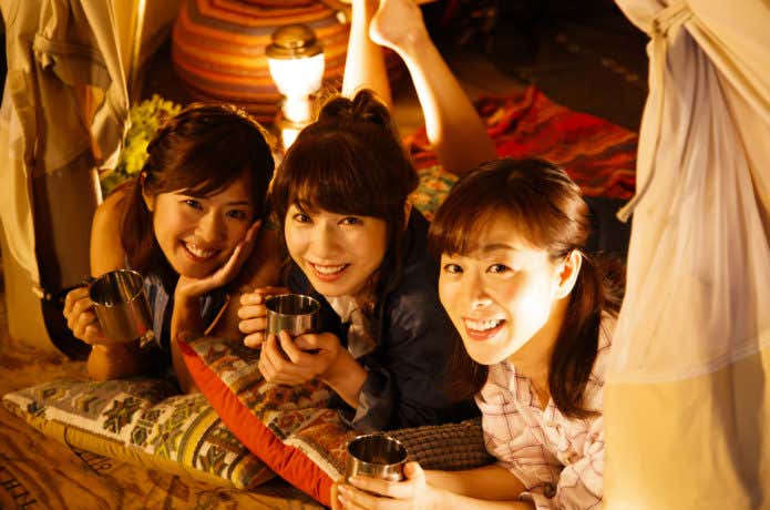 仲間とテントに泊まる女性