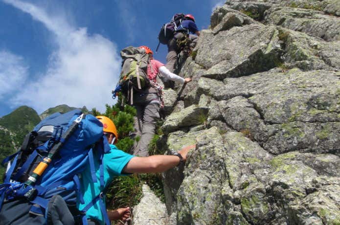 ヘルメットを被って登山する人