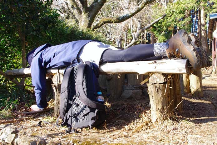 ベンチでうなだれる登山者