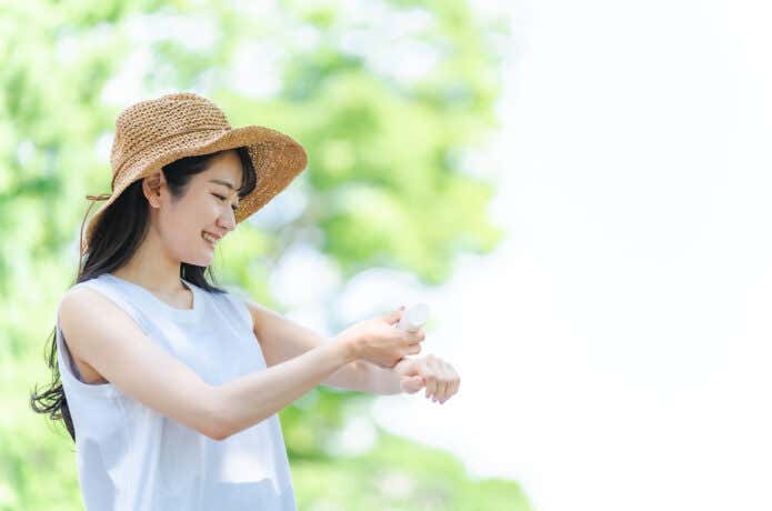 肌に何かをつける女性