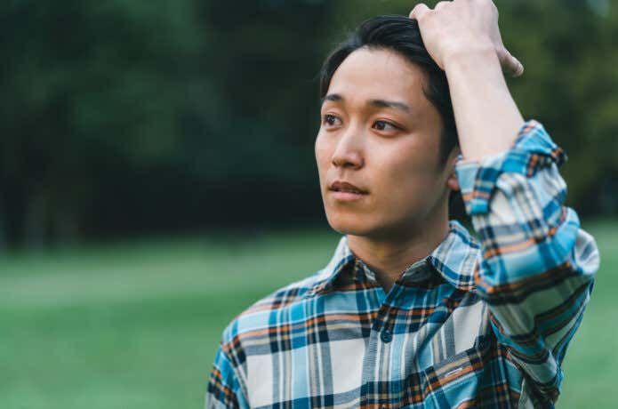 髪を触る男性