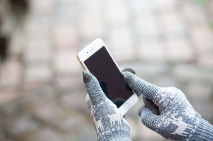 手袋をしてスマホを持った手元