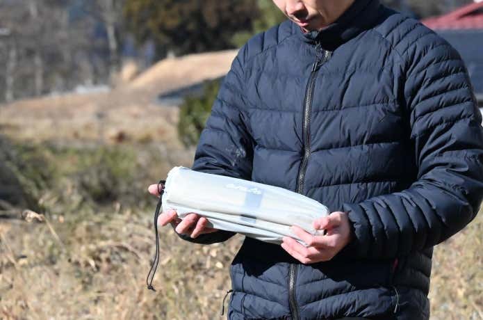 収納されたarataのマットを抱えている人