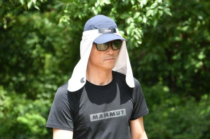 エヌリット クーリングガードをキャップの上に着用した男性