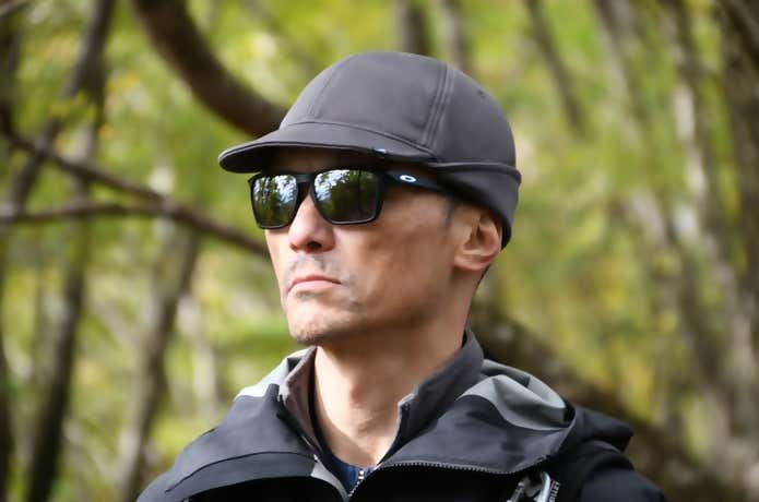 カリマーのウォームイヤーカバーキャップのイヤーカバーを上に折りたたみ、耳を出してかぶった男性