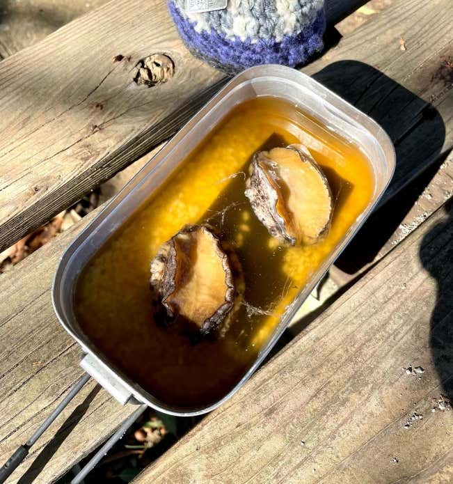 ①メスティンに洗ったお米、白だし、しょうゆ、酒を入れて、内側のリベット(丸い突起)の中心まで水を加えて調整する。
②お米の上に昆布、その上にあわびをのせ、フタをして固形燃料で約20分炊く。